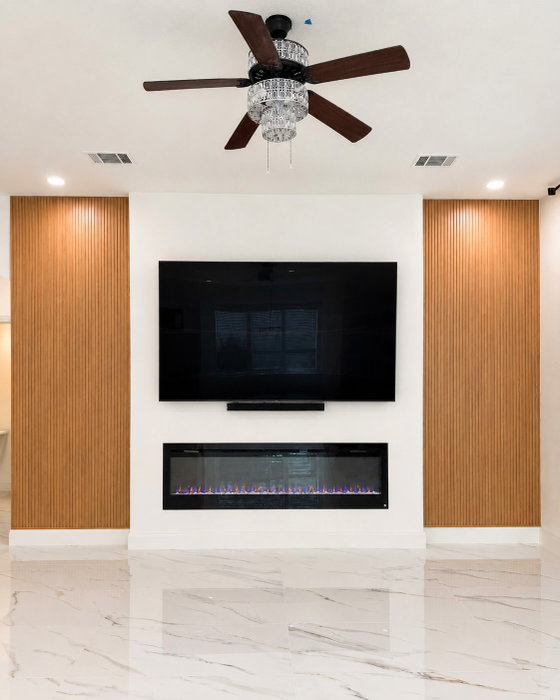 Fluted wood accent walls, floating fireplace, and modern flooring.

This living room feature wall is