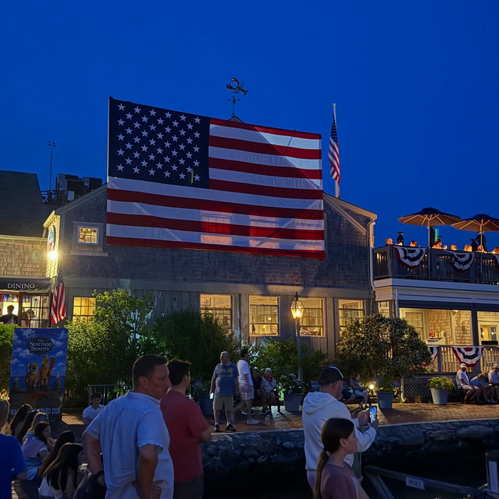 4th of July night in Edgartown. Big flag up on the waterfront, crowd out along the harbor.Visit: ht...