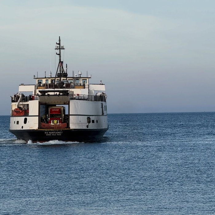 The Nantucket easing in with the bow doors open. A red Cape Cod Express truck up front, deckhand sta...