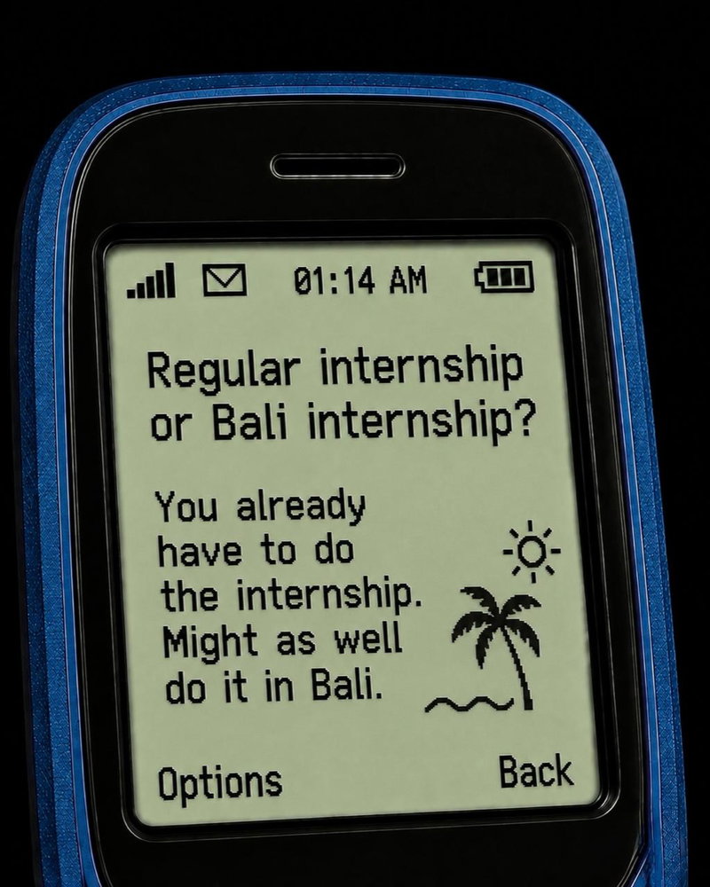 Close-up of a retro blue mobile phone displaying the message: “Regular internship or Bali internshi…