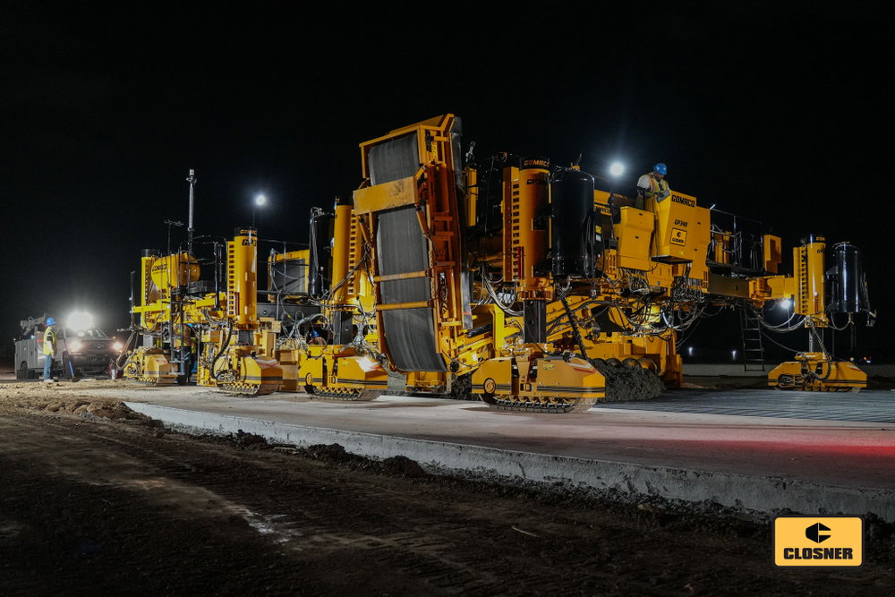 The GOMACO GP-348 feeding a GP-3, and this setup means business. Serious iron, continuous production, and concrete paving at work.