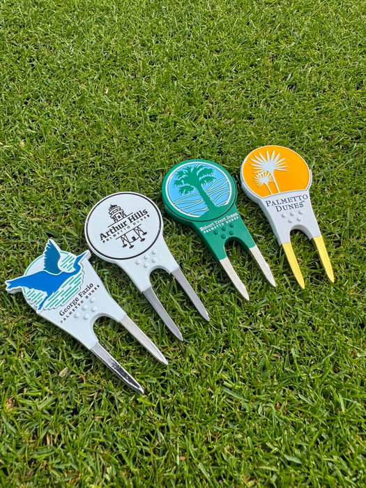 The perfect souvenir before or after a round, a divot tool and ball marker all-in-one! 🏌️‍♂️Collect all of our Pac Golf accessories custom made for each course, available at the Robert Trent Jones, Arthur Hills, and George Fazio Golf Pro Shops in Palmetto Dunes Resort. ⛳️

To learn more about our golf pro shops & resort shopping, visit the 'Golf' link in our bio.