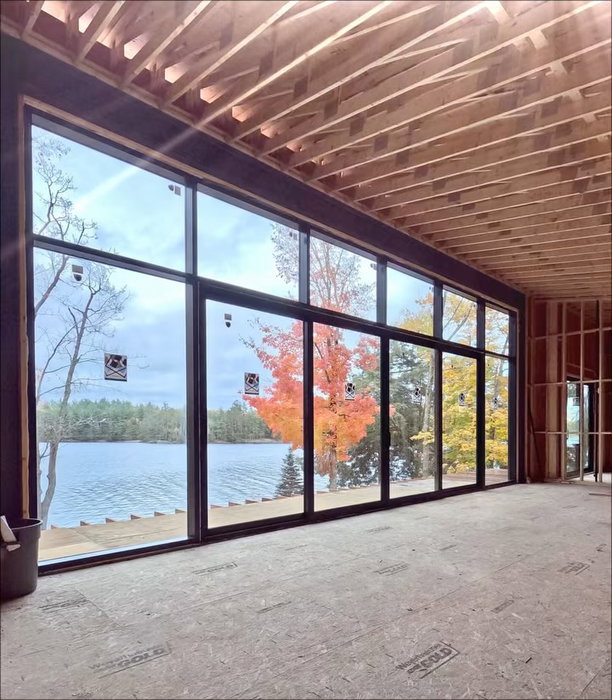 Swipe through the work behind the view.

On a point overlooking Jack Lake: a large curtain wall and four-panel lift-and-slide door, installed by the Everlast Fenestrators with tempered Cardinal LoĒ-366 glass for solar control.

Trust the process. Trust Everlast.